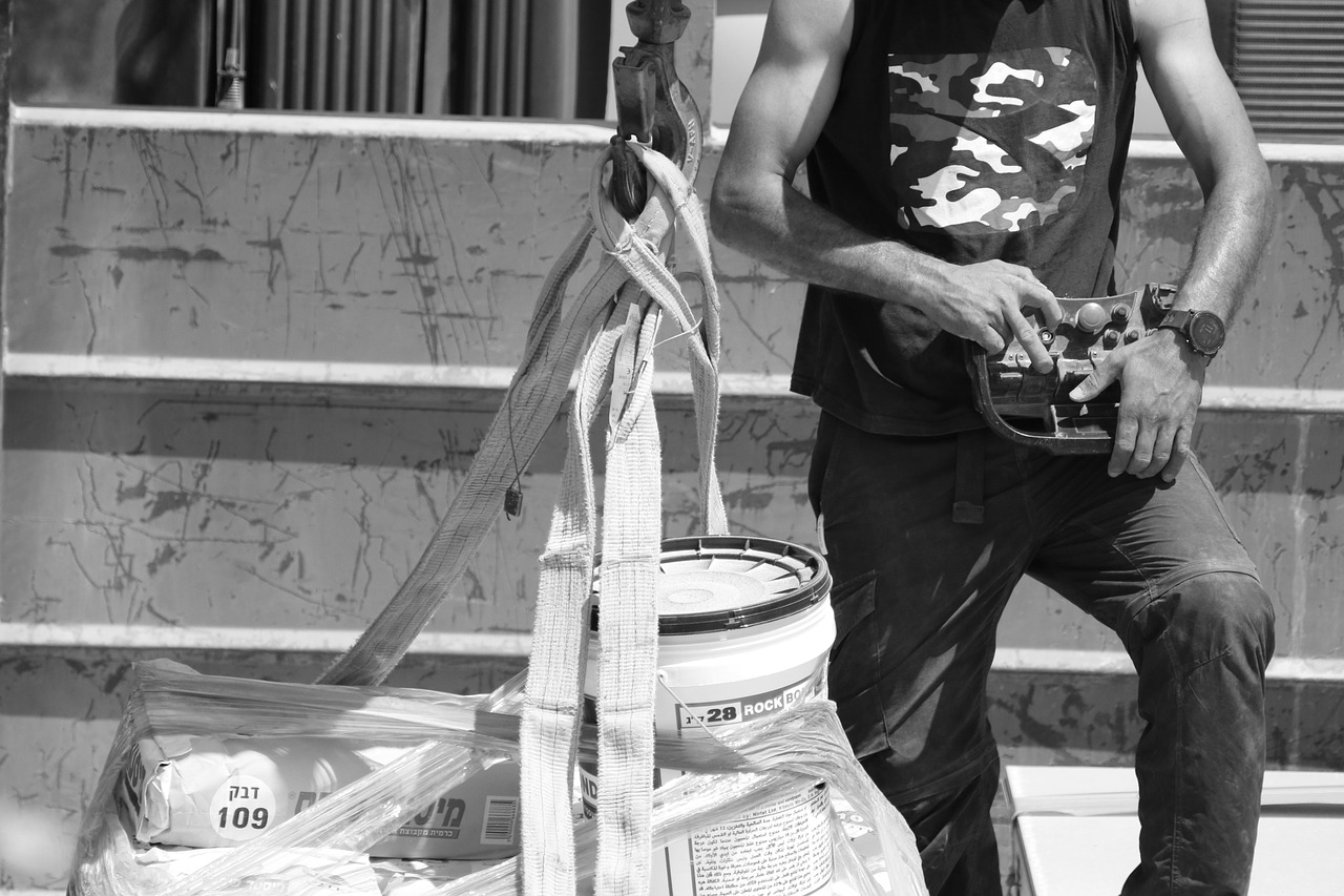 man, at work, crane, machine, ropes, remote control, gray work